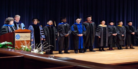Faculty members wait to be honored on stage